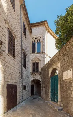 an old stone building with a green door at Old Town St Tryphon Apartment in Kotor