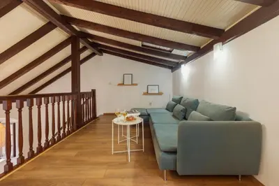 a living room with a blue couch and a table at Old Town St Tryphon Apartment in Kotor