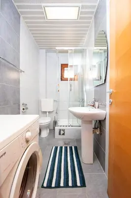 a bathroom with a sink and a washing machine at Budva Apartment Nadja in Budva