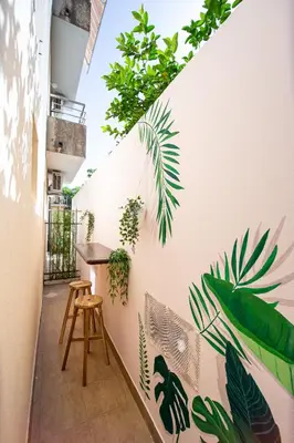 a balcony with plants on the wall of a building at Budva Apartment Nadja in Budva