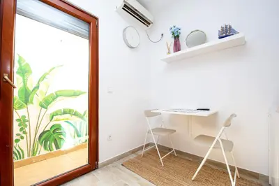 a room with a desk and a sliding glass door at Budva Apartment Nadja in Budva