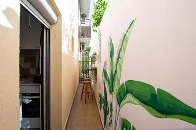 a hallway with a mural of plants on the wall at Budva Apartment Nadja in Budva