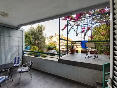 a view from the balcony of a house with a large window at Apartman M&U in Petrovac na Moru