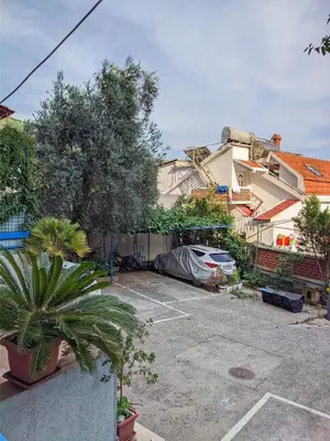a car parked in a parking lot next to a building at Apartman M&U in Petrovac na Moru