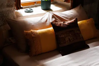 a bed with several pillows on it with a window at HealthyStudio512 Apartments in Kotor