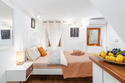 a bedroom with a bed and a bowl of fruit at HealthyStudio512 Apartments in Kotor