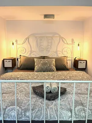a bedroom with a large bed with two night stands at HealthyStudio512 Apartments in Kotor