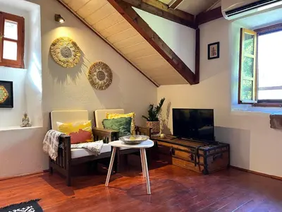 a living room with a tv and a table and chairs at HealthyStudio512 Apartments in Kotor
