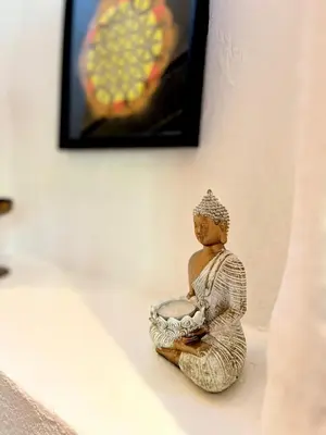 a figurine of a woman sitting on a wall at HealthyStudio512 Apartments in Kotor