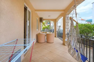 a porch with a hammock on a balcony at Apartman AS in Budva