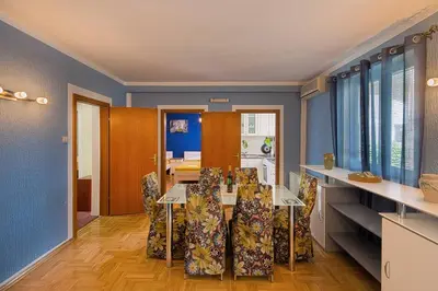 a dining room with a table and chairs at Apartman AS in Budva
