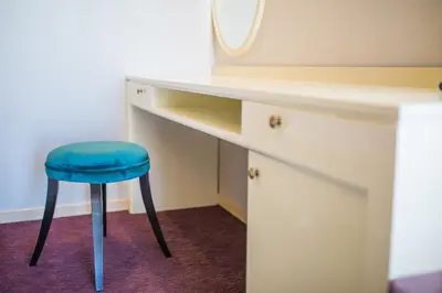 a stool sitting next to a desk with a mirror at Villa Katarina in Budva