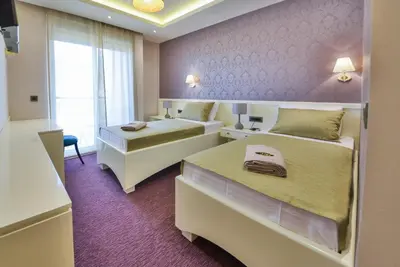 a hotel room with two beds and a window at Villa Katarina in Budva