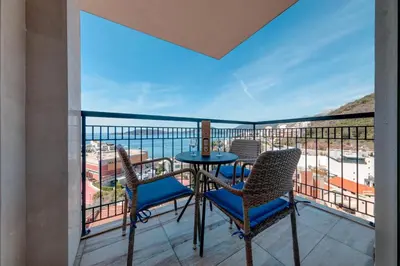 a balcony with a table and chairs and a view of the ocean at Villa Katarina in Budva