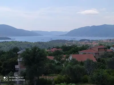 a view of a town with a lake and mountains at Apartman Andjela in Kavač