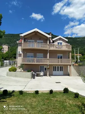 a large house with a balcony on top of it at Apartman Andjela in Kavač