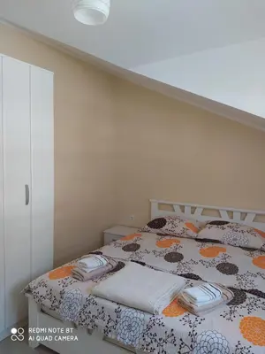 a bedroom with a bed with towels on it at Apartman Andjela in Kavač