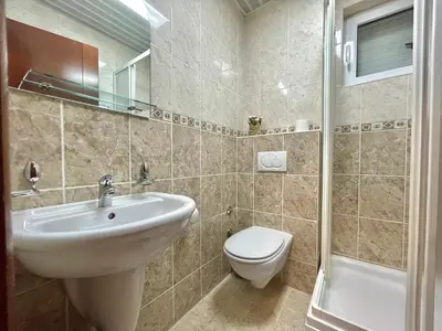 a bathroom with a sink and a toilet at Apartments Boreta Becici in Budva