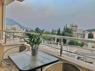 a table with a vase on top of a balcony at Apartments Boreta Becici in Budva
