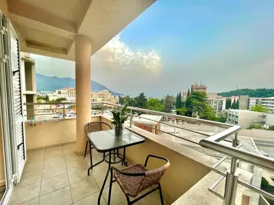 a balcony with a table and chairs and a view at Apartments Boreta Becici in Budva