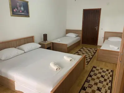 a room with two beds and a room with at Beqa Apartments in Ulcinj