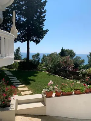 a garden with potted plants on a stair case at Beqa Apartments in Ulcinj