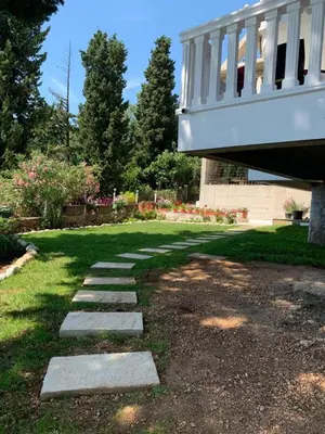 a stepping stone path in a yard under a bridge at Beqa Apartments in Ulcinj