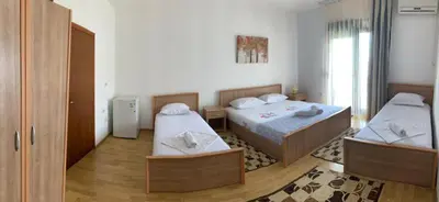 a bedroom with two beds and a window at Beqa Apartments in Ulcinj