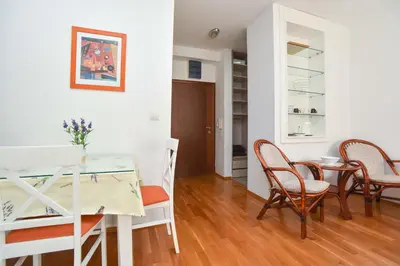 a kitchen and dining room with a table and chairs at Modern Studio 200m from the Beach in Budva