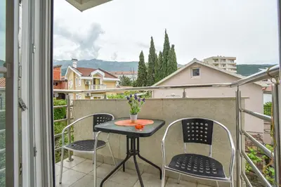 a small table and chairs on a balcony with a view at Modern Studio 200m from the Beach in Budva