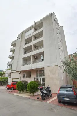 a building with a motorcycle parked in front of it at Modern Studio 200m from the Beach in Budva