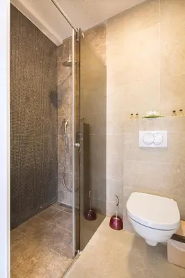a bathroom with a toilet and a shower at City center lux apartment in Budva
