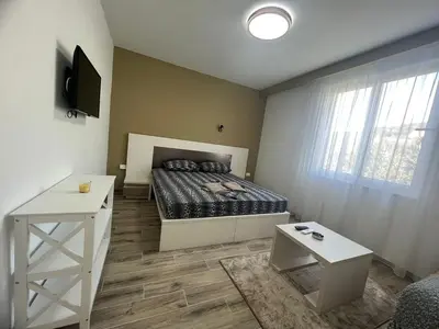 a small bedroom with a bed and a table at Apartments San with Sea View in Dobra Voda