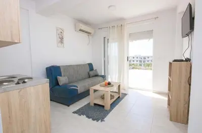 a living room with a couch and a table at Apartments San with Sea View in Dobra Voda