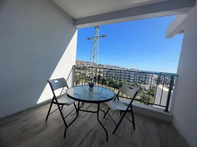 a table and chairs on a balcony with a view at Apartments San with Sea View in Dobra Voda