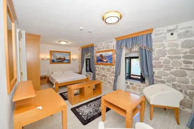 a living room with a stone wall at SEASIDE HOUSE KOTOR in Kotor