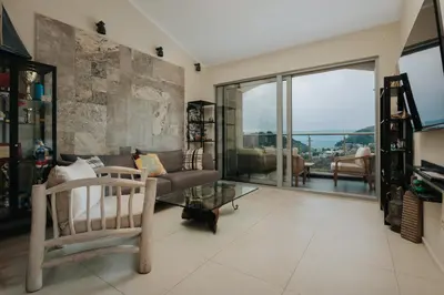 a living room with a couch and a glass table at The View apartment in Petrovac na Moru