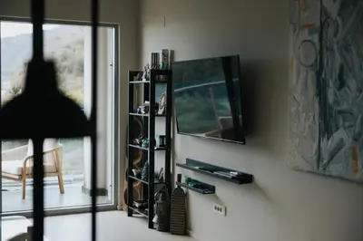 a person standing in a living room with a mirror at The View apartment in Petrovac na Moru