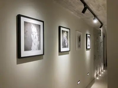 a group of framed photographs on a wall at The View apartment in Petrovac na Moru