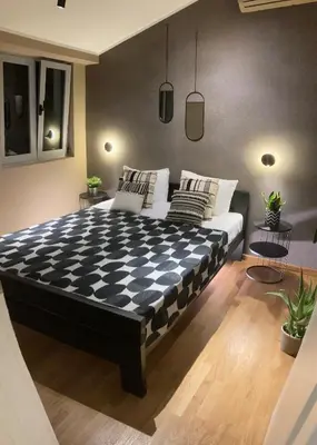 a bedroom with a large bed with a checkered floor at The View apartment in Petrovac na Moru