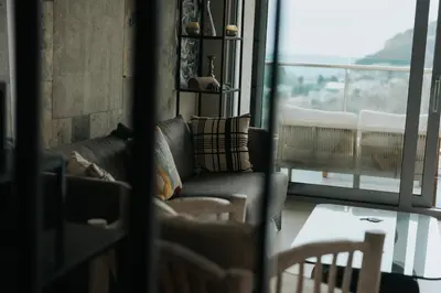 a living room with a couch and a large window at The View apartment in Petrovac na Moru