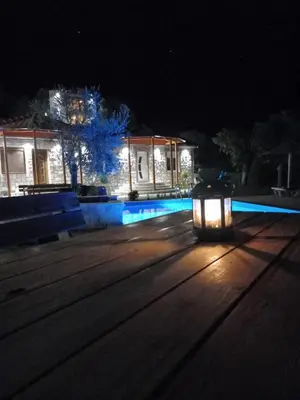 a lantern on the street in front of a house at night at Rustic Villas Barlovic in Ulcinj