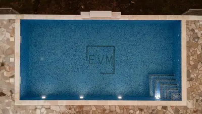 a large pool of blue water in a building at Etno Villa Mokanji in Danilovgrad