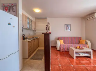 a kitchen and a living room with a couch and a table at Casa al mare Petrovac, Montenegro in Petrovac na Moru