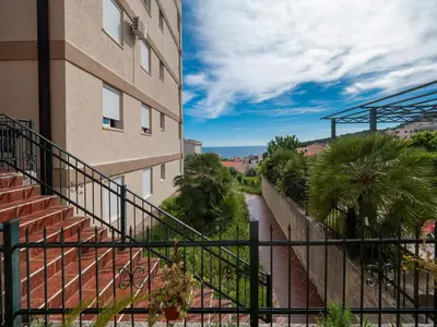 a building with a staircase next to a building at Casa al mare Petrovac, Montenegro in Petrovac na Moru