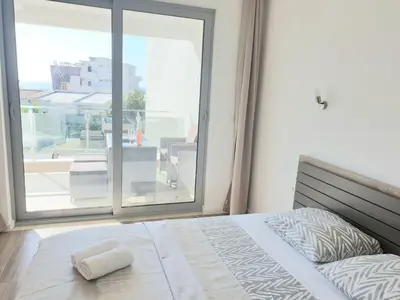 a bedroom with a bed and a large window at Apart sunset in Bar