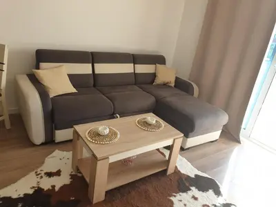 a living room with a couch and a coffee table at Apart sunset in Bar