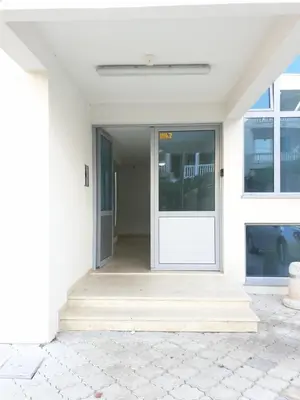 an open door of a white house with a porch at Apart sunset in Bar