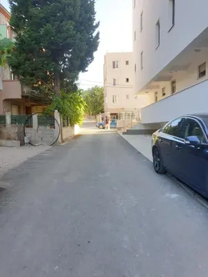 a car parked on the side of a street at Apart sunset in Bar