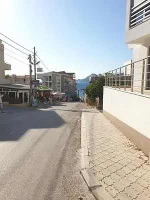 an empty street in a town with a building at Apart sunset in Bar